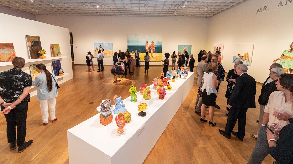 people looking at exhibit featuring paintings and sculptures at Orlando Museum of Art in Orlando, Florida, USA